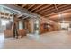 Unfinished basement area with open ceiling, concrete floors, and wood support beams, ready for customization at 1725 Mountainside Dr, Cumming, GA 30040