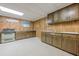 A finished basement includes a kitchen with wood paneling and updated appliances at 1725 Mountainside Dr, Cumming, GA 30040