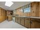 A finished basement includes a kitchen with wood paneled walls and storage at 1725 Mountainside Dr, Cumming, GA 30040