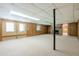 Finished basement with a brick fireplace, carpet, wood panel walls, and a bright drop ceiling, perfect for entertaining at 1725 Mountainside Dr, Cumming, GA 30040