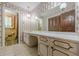 A vintage bathroom with floral wallpaper, a vanity with white countertops and gold trim at 1725 Mountainside Dr, Cumming, GA 30040