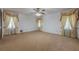 The bedroom features neutral carpets, a ceiling fan, and curtains for a comfortable space at 1725 Mountainside Dr, Cumming, GA 30040