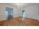 A dining room with crown molding and hardwood floors next to a chandelier, elegant and spacious at 1725 Mountainside Dr, Cumming, GA 30040