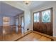 This entryway features elegant double doors, hardwood floors, and a stunning chandelier at 1725 Mountainside Dr, Cumming, GA 30040