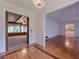 This foyer boasts hardwood floors, lovely wallpaper, and an arched opening into a living room at 1725 Mountainside Dr, Cumming, GA 30040