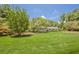 Manicured front lawn and mature landscaping showcasing this brick home with timeless elegance at 1725 Mountainside Dr, Cumming, GA 30040