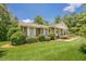 Traditional brick home with white columns, shutters and a well-manicured lawn at 1725 Mountainside Dr, Cumming, GA 30040