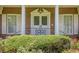 Close up view of a front door with leaded glass sidelights and brick exterior with white pillars and trim at 1725 Mountainside Dr, Cumming, GA 30040