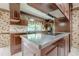 Traditional kitchen featuring dark wood cabinetry, tile flooring, and a kitchen island with cooktop at 1725 Mountainside Dr, Cumming, GA 30040