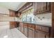 Traditional kitchen featuring wood cabinetry, light countertops and appliances, tile floors and backsplash at 1725 Mountainside Dr, Cumming, GA 30040
