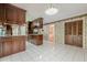 Open kitchen features tile flooring, dark cabinetry and eat-in dining space at 1725 Mountainside Dr, Cumming, GA 30040