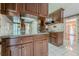 Traditional kitchen featuring dark wood cabinetry, light countertops, tile backsplash and floors at 1725 Mountainside Dr, Cumming, GA 30040