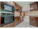 Traditional kitchen featuring wood cabinetry, with built-in microwave and oven combination at 1725 Mountainside Dr, Cumming, GA 30040