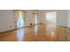 Bright living room features gleaming hardwood floors and a large window, perfect for entertaining at 1725 Mountainside Dr, Cumming, GA 30040