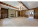 Large living room with stone fireplace, built-in shelving, carpet and view of entryway at 1725 Mountainside Dr, Cumming, GA 30040