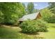 Charming outbuilding nestled amongst the trees with a covered porch perfect for relaxing at 1725 Mountainside Dr, Cumming, GA 30040