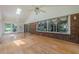 Light-filled sunroom features hardwood floors, brick accents, and large windows offering serene views at 1725 Mountainside Dr, Cumming, GA 30040