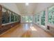 Hardwood floors, and large windows offering serene views in this light-filled sunroom at 1725 Mountainside Dr, Cumming, GA 30040