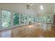 Bright sunroom with hardwood floors, skylights, ceiling fans and expansive windows overlooking lush greenery at 1725 Mountainside Dr, Cumming, GA 30040