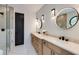 Modern bathroom featuring double vanity with round mirrors and a glass enclosed shower at 3960 Clairmont Rd # 2, Chamblee, GA 30341
