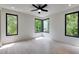 Bright bedroom with hardwood floors, a ceiling fan, and expansive windows offering lush views at 3960 Clairmont Rd # 2, Chamblee, GA 30341
