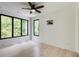 Bedroom with hardwood floors, a ceiling fan, and expansive windows offering lush views at 3960 Clairmont Rd # 2, Chamblee, GA 30341