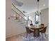 An inviting dining area with modern chandelier, table, and chairs, adjacent to staircase at 3960 Clairmont Rd # 2, Chamblee, GA 30341
