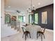 Bright dining area with stylish chandelier, hardwood floors, and staircase at 3960 Clairmont Rd # 2, Chamblee, GA 30341