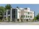 Modern townhome exterior with a combination of brick and metal paneling, large windows, and manicured landscaping at 3960 Clairmont Rd # 2, Chamblee, GA 30341