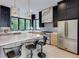 Modern kitchen with an island, stainless steel appliances, stylish pendant lights, and large windows at 3960 Clairmont Rd # 2, Chamblee, GA 30341