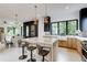 Modern kitchen with an island, stainless steel appliances, stylish pendant lights, and large windows at 3960 Clairmont Rd # 2, Chamblee, GA 30341