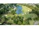 Aerial view of the golf course with a pristine lake and manicured greens at 5995 Ettington Dr, Suwanee, GA 30024