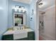 Stylish bathroom with a green vanity, gold accents, and a walk-in glass shower at 5995 Ettington Dr, Suwanee, GA 30024