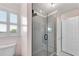 Bright bathroom with a glass shower featuring gray tile and a window letting in natural light at 5995 Ettington Dr, Suwanee, GA 30024