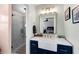 Elegant bathroom featuring a navy vanity with a farmhouse sink and a glass-enclosed shower at 5995 Ettington Dr, Suwanee, GA 30024