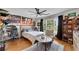 Comfortable bedroom with hardwood floors, natural light, and sports-themed decor at 5995 Ettington Dr, Suwanee, GA 30024