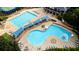 Resort-style community pool area with lap pool, lounge area, and shaded seating options at 5995 Ettington Dr, Suwanee, GA 30024