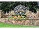 A stately stone community sign welcomes residents to Laurel Springs, a Golden Bear Community at 5995 Ettington Dr, Suwanee, GA 30024