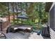 Outdoor deck with seating, grill, and view of lush landscaping at 5995 Ettington Dr, Suwanee, GA 30024