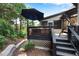 Deck area with outdoor seating, a porch swing, and shade umbrella at 5995 Ettington Dr, Suwanee, GA 30024