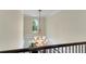 Grand two-story foyer featuring an elegant chandelier and staircase with iron railing at 5995 Ettington Dr, Suwanee, GA 30024