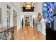 Elegant two-story foyer featuring gleaming hardwood floors, wainscoting, and a view of the living spaces at 5995 Ettington Dr, Suwanee, GA 30024
