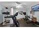 Home gym with treadmill, stationary bike, weights and mounted TV at 5995 Ettington Dr, Suwanee, GA 30024