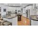 Spacious kitchen features granite countertops, stainless steel appliances, and breakfast bar seating at 5995 Ettington Dr, Suwanee, GA 30024