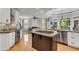 Gourmet kitchen with granite countertops, custom cabinets, and a center island cooktop at 5995 Ettington Dr, Suwanee, GA 30024