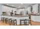 Modern kitchen with a large island, white cabinetry, granite countertops, stainless steel appliances and barstool seating at 5995 Ettington Dr, Suwanee, GA 30024