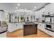 Bright kitchen has a center island cooktop, granite counters, and stainless appliances at 5995 Ettington Dr, Suwanee, GA 30024