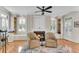 Cozy sitting area with a fireplace, bookshelves, and lots of natural light at 5995 Ettington Dr, Suwanee, GA 30024
