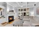 Bright living room features a fireplace, large sectional sofa, and coffered ceilings at 5995 Ettington Dr, Suwanee, GA 30024