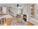 Sitting area next to kitchen has a fireplace, built-in shelves and stairway at 5995 Ettington Dr, Suwanee, GA 30024